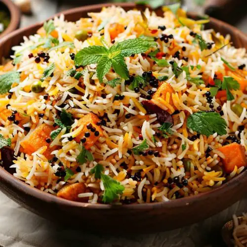 Veg Biriyani served in a bowl garnished with mint and cilantro