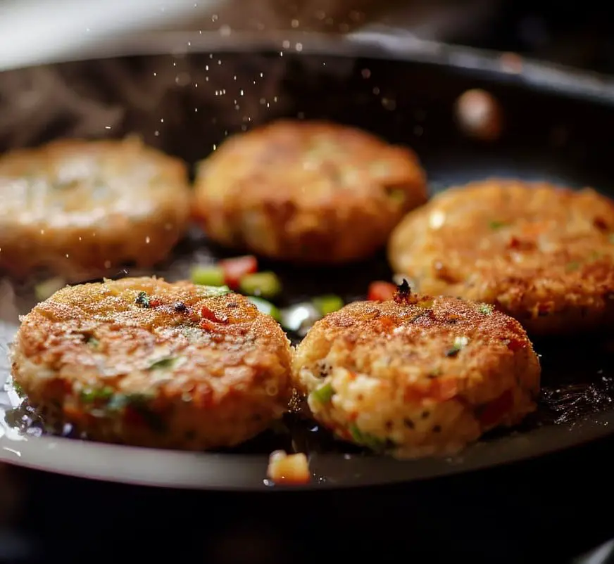 Aloo tikki cooking in a pan