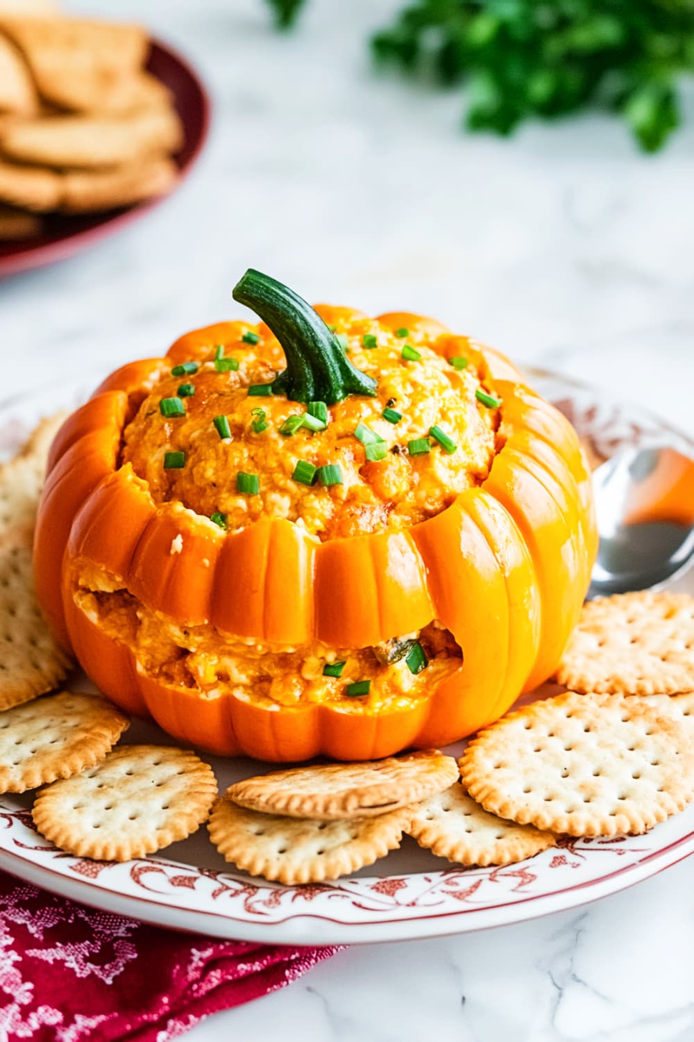 Pumpkin_Cheeseball_Recipe with crackers sliced and cheese coming out