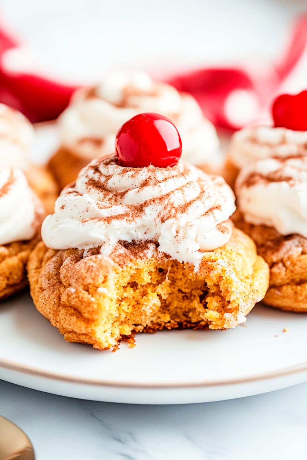 Snickerdoodle pumpkin cookies with cheese cream frosting and cherrya