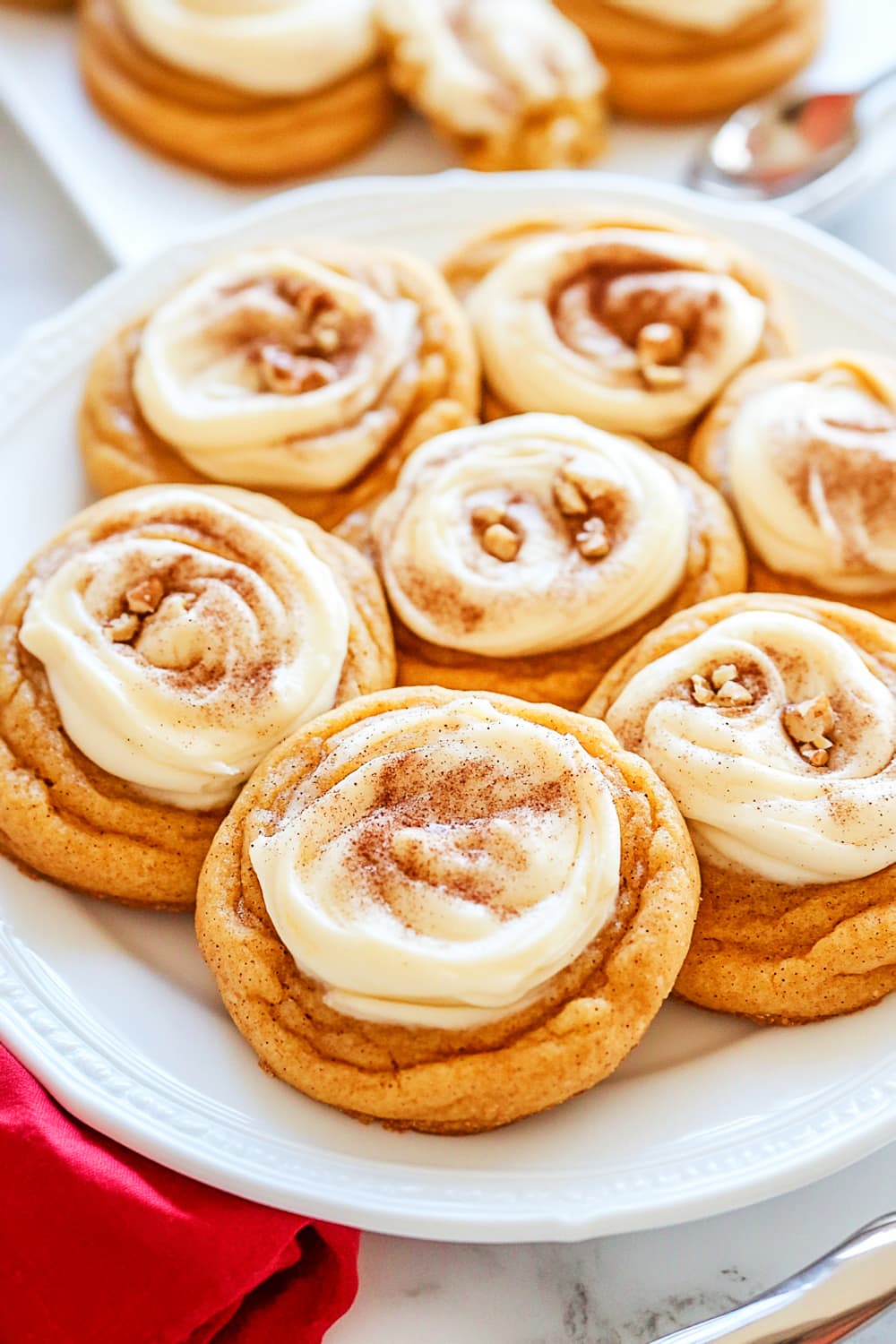 Snickerdoodle pumpkin cookies with cheese cream frosting, crushed nuts