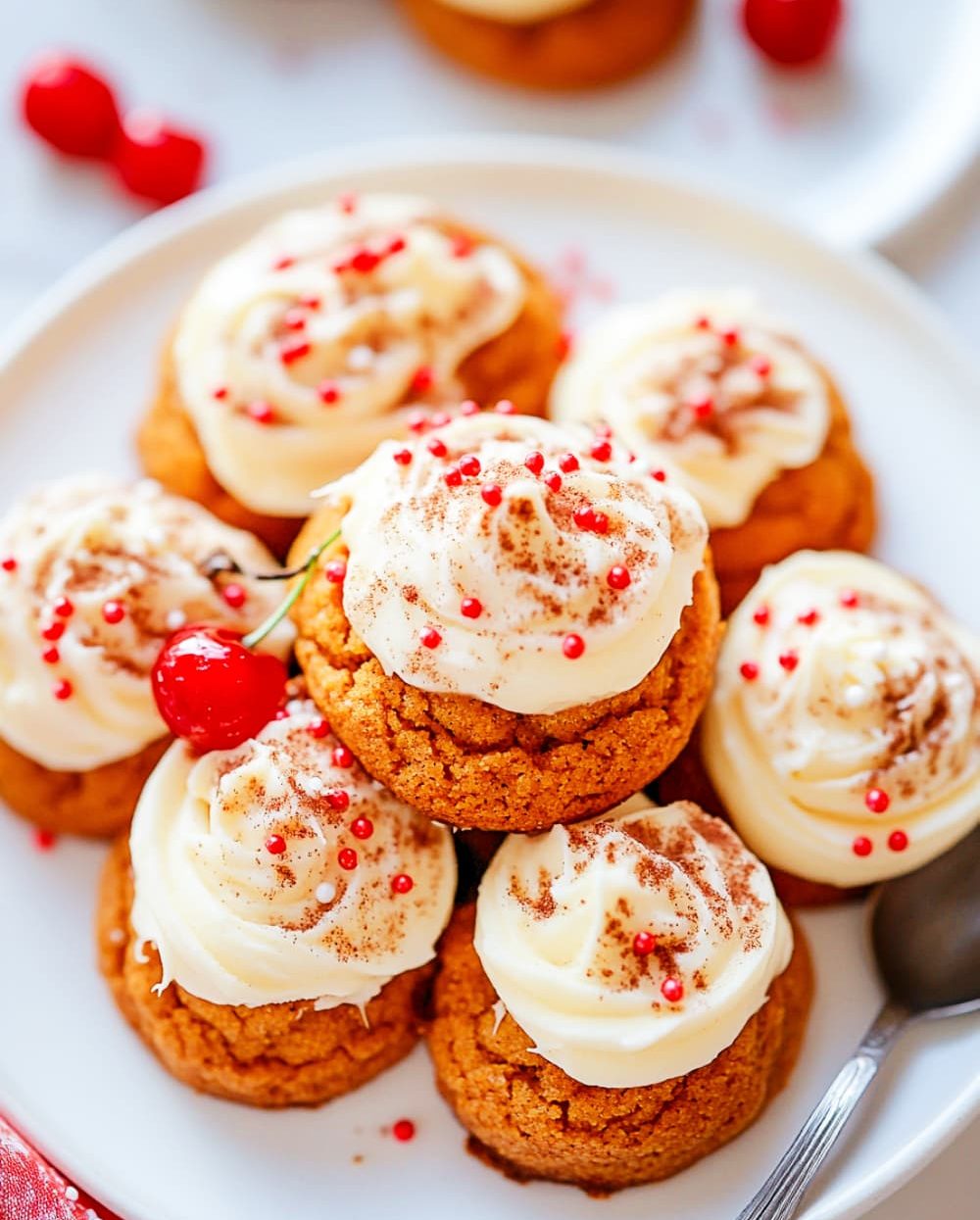 Snickerdoodle pumpkin cookies with cheese cream frosting, sprinkles and cherry