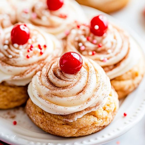 Snickerdoodle pumpkin cookies with cheese cream frosting, sprinkles and cherry