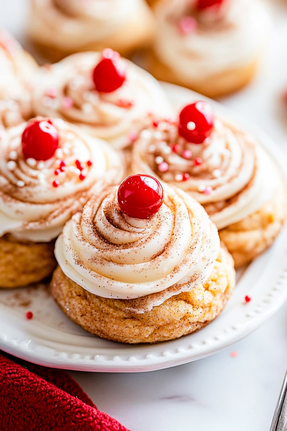 Snickerdoodle pumpkin cookies with cheese cream frosting, sprinkles and cherry