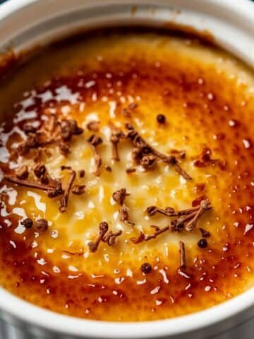 Rich and creamy Crab Brûlée Recipe with a perfectly caramelized golden-brown crust, garnished with delicate herbs for an elegant finish.