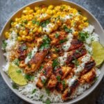 Healthy Street Corn Chicken Rice Bowl with grilled chicken, charred corn, white rice, lime wedges, and cilantro-lime crema drizzle.