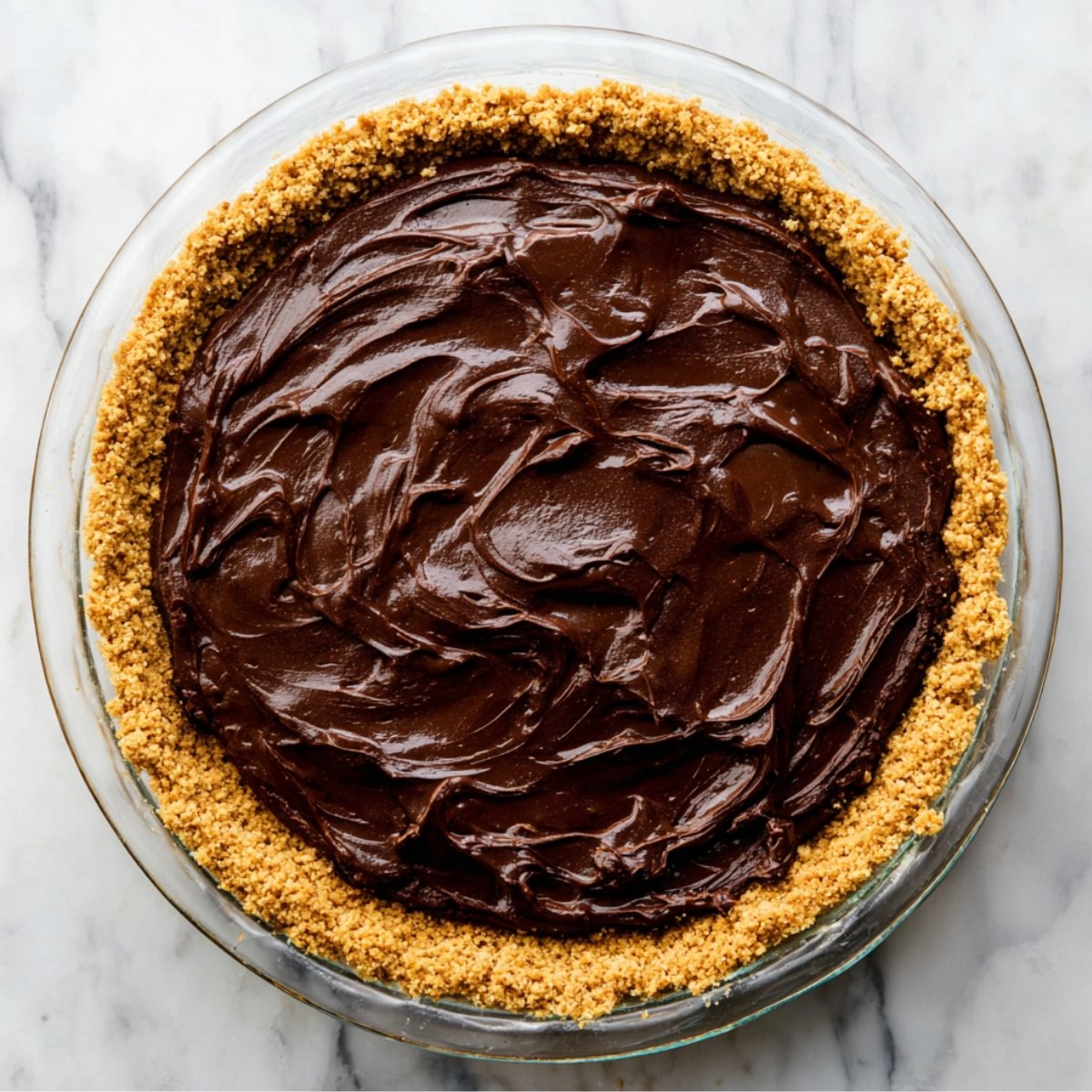 Gently fold the chocolate chips into the thick batter using a spatula. Immediately spoon this batter into your prepared graham cracker crust and spread it evenly.