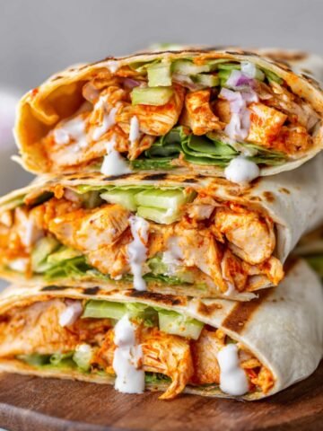 Homemade Buffalo Chicken Wraps filled with shredded chicken, lettuce, celery, and a drizzle of ranch dressing.
