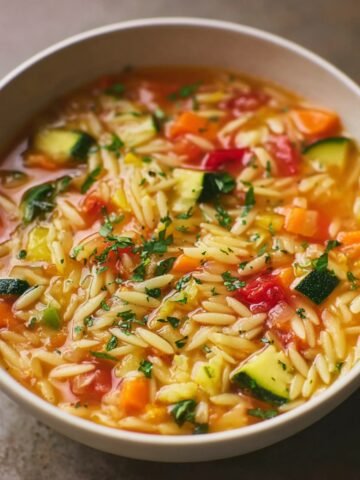 Homemade Orzo Vegetable Soup with diced vegetables and fresh herbs.