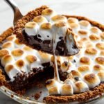 Homemade S'mores Brownie Pie with toasted marshmallows, gooey chocolate filling, and a graham cracker crust.