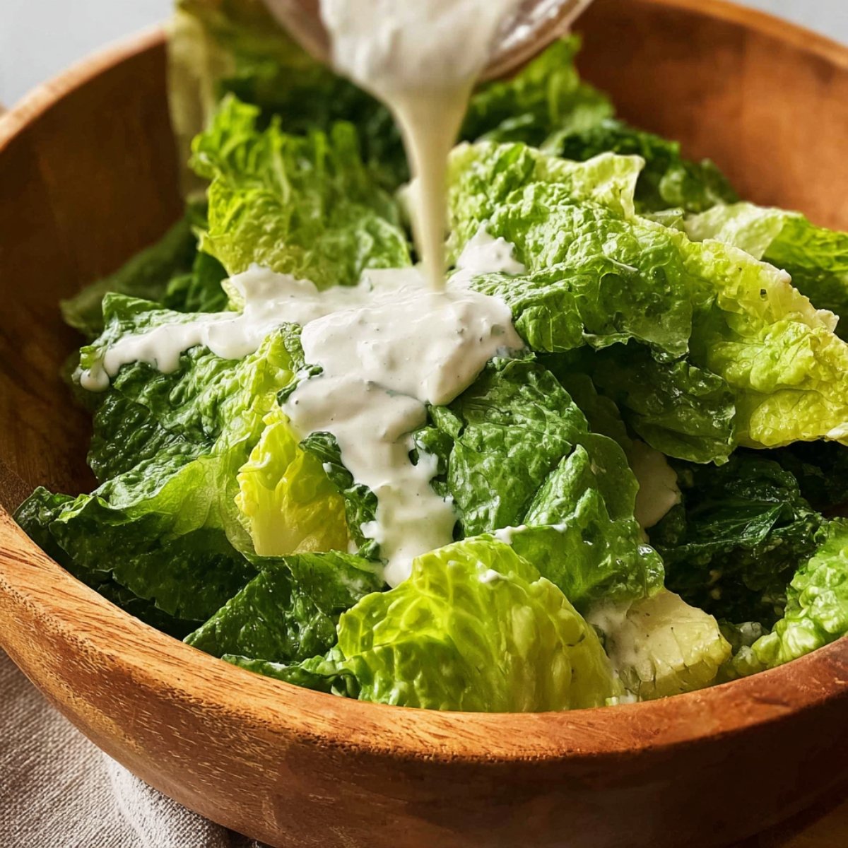 Combine the mayo, Greek yogurt, Dijon, Worcestershire, lemon juice, grated Parmesan, minced garlic, black pepper, and a pinch of salt in a bowl. Stir everything together until it's smooth and creamy. Scoop out 4 to 5 tablespoons of the dressing and toss it with the chopped romaine in a medium bowl to make your Caesar salad. Cover both the dressed salad and the remaining dressing, then pop them in the fridge until you're ready to assemble.