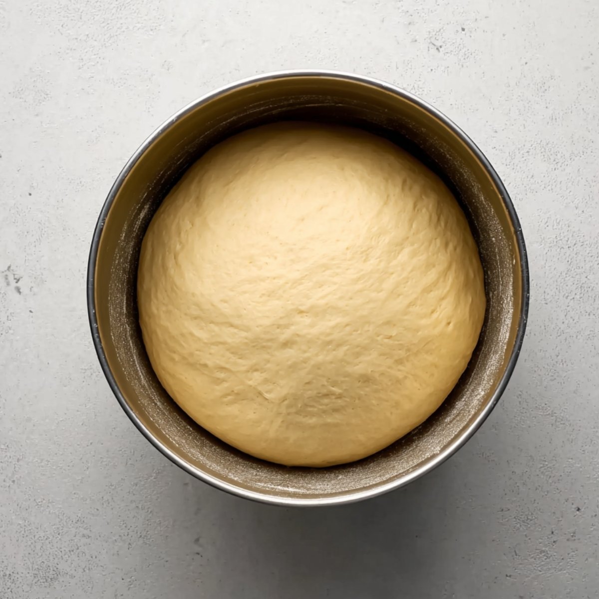 Warm the milk and butter together in a small saucepan over low heat until the butter melts completely. Let it sit until it's just lukewarm to the touch. Pour it into your stand mixer bowl fitted with the dough hook, then add the honey, eggs, bread flour, yeast, and salt. Mix on low speed for about a minute until everything comes together into a shaggy dough. Bump the speed up to medium and let it knead for 6 minutes. The dough should pull away from the sides of the bowl and feel smooth and elastic, not sticky. Transfer it to a lightly greased bowl, cover it with a towel.