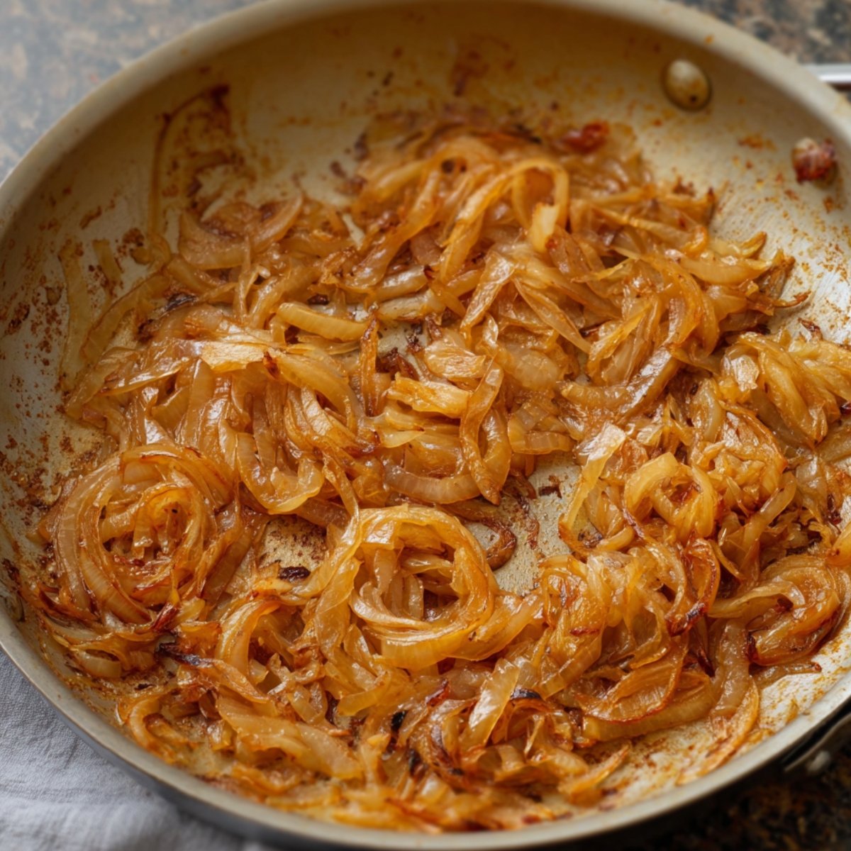 Seasoning and flavors being added to caramelized onions for a rich, savory base.