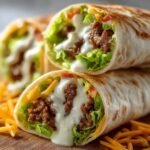 Stack of delicious Big Mac Wraps with seasoned beef, lettuce, cheese, and creamy sauce, cut in half to show the filling inside.