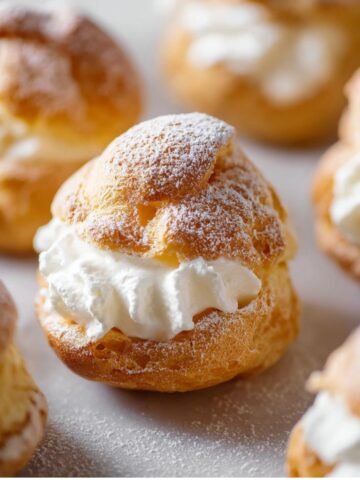 Choux Pastry with a fluffy whipped cream filling, dusted lightly with powdered sugar.