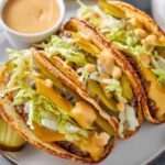 Big Mac Smash burger Tacos with pickles, lettuce, and melted cheese inside soft taco shells with drizzle of special sauce.