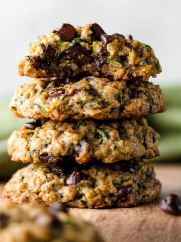 A stack of freshly baked Zucchini Chocolate Chip Cookies, showcasing their golden-brown edges and soft, chewy texture.