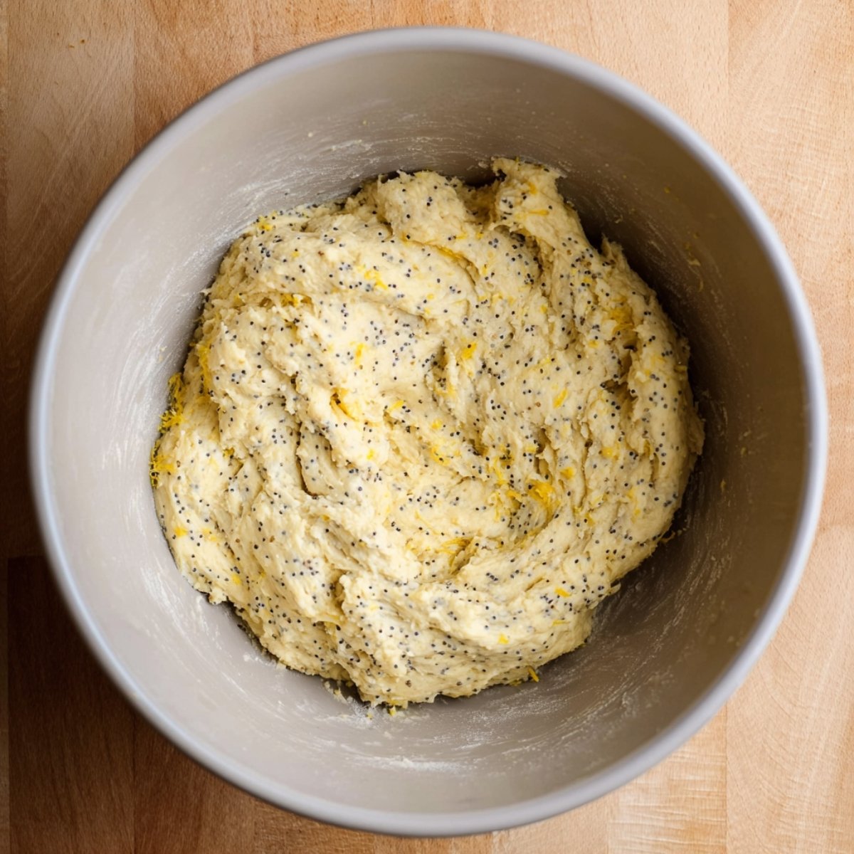 A close-up of the lemon poppy seed cookie dough in a mixing bowl before baking.